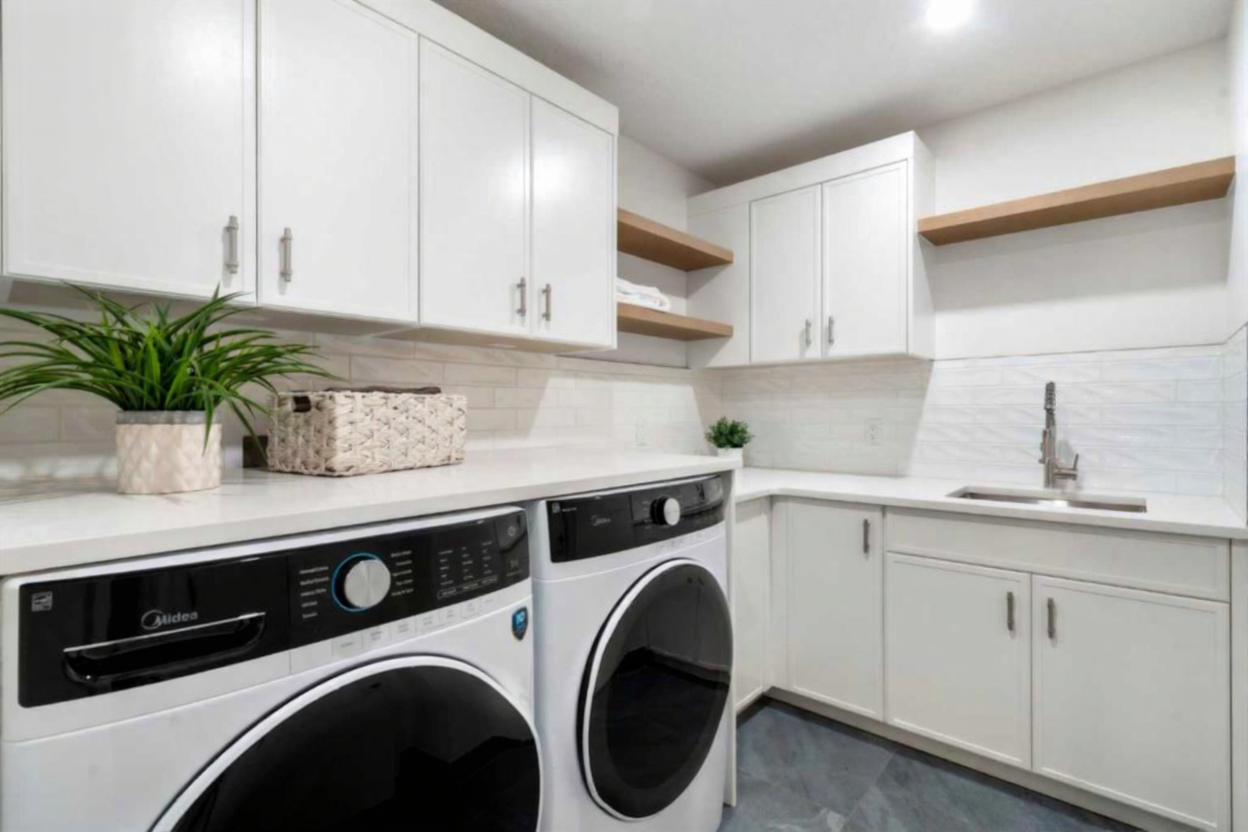 White laundry room with MDF doors by Bow Wood Co. Calgary